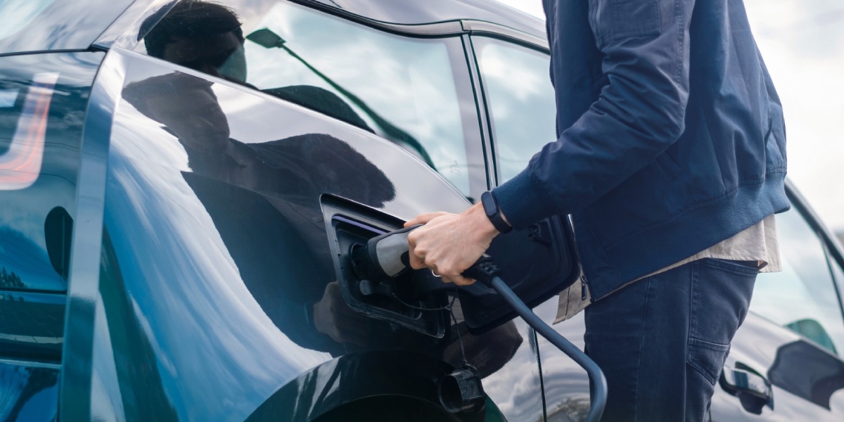 A person charging an EV