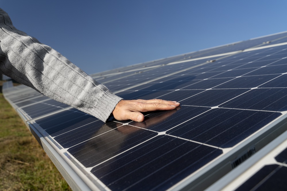 Hand on solar panel