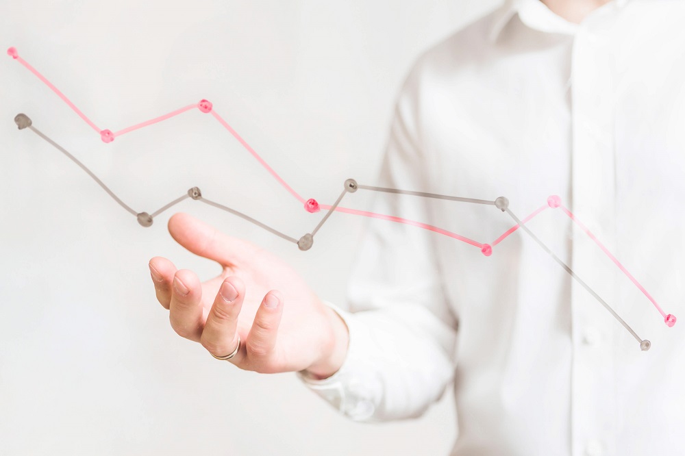 A man presenting a line chart on hand