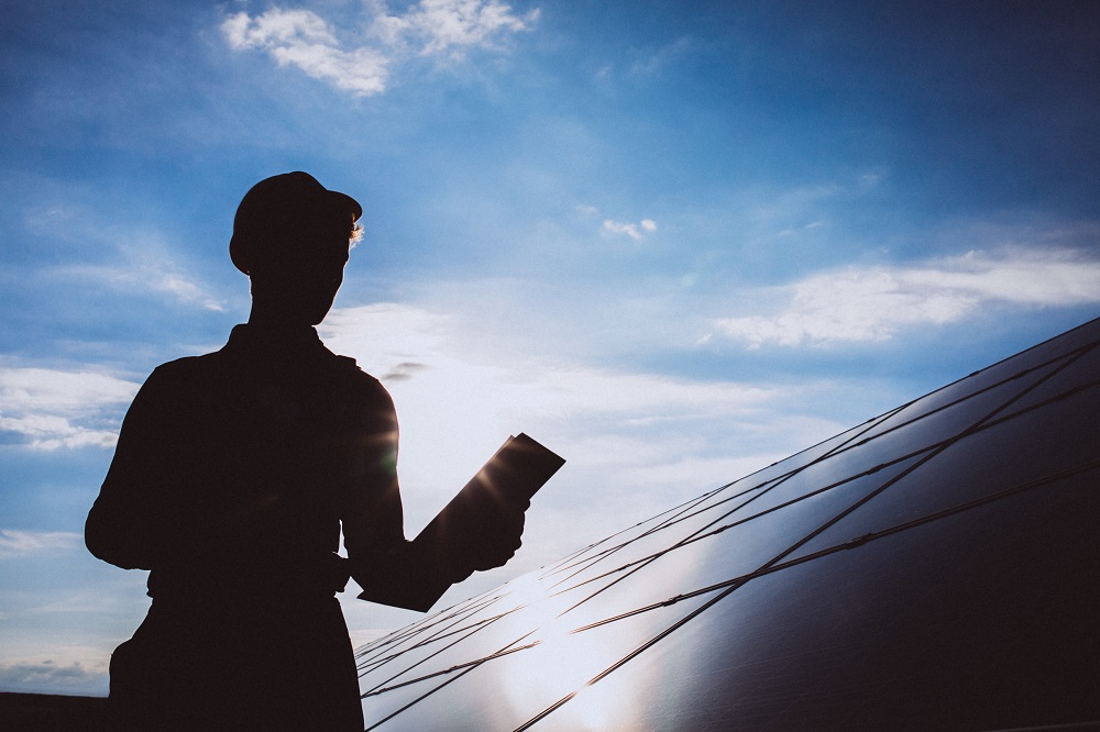 Solar employee checking solar panel functionality