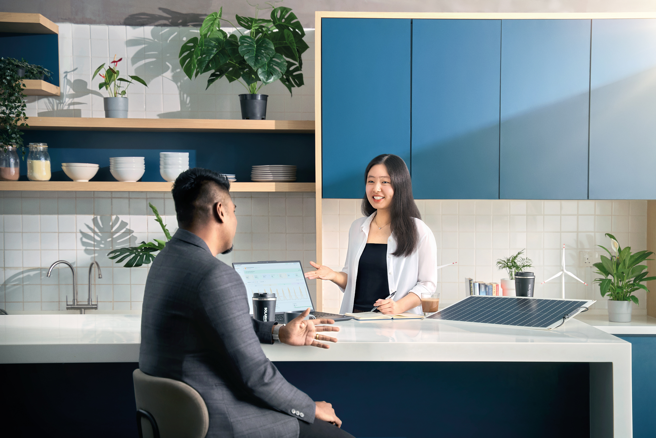 Two professionals meeting in modern kitchen office.